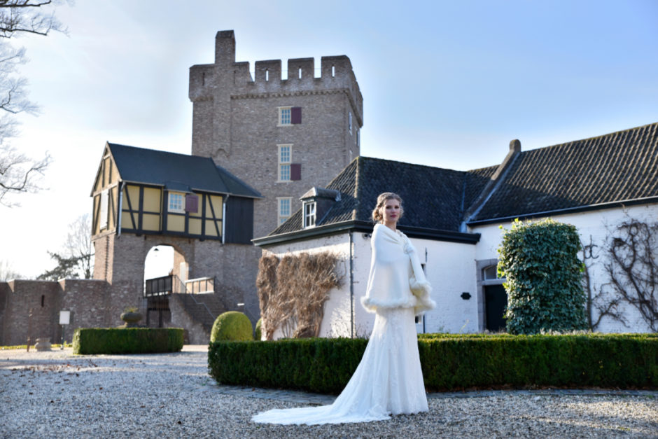 Bride posing at castle Dealenbroeck in Herkenbosch near Roermond. Wedding photography.